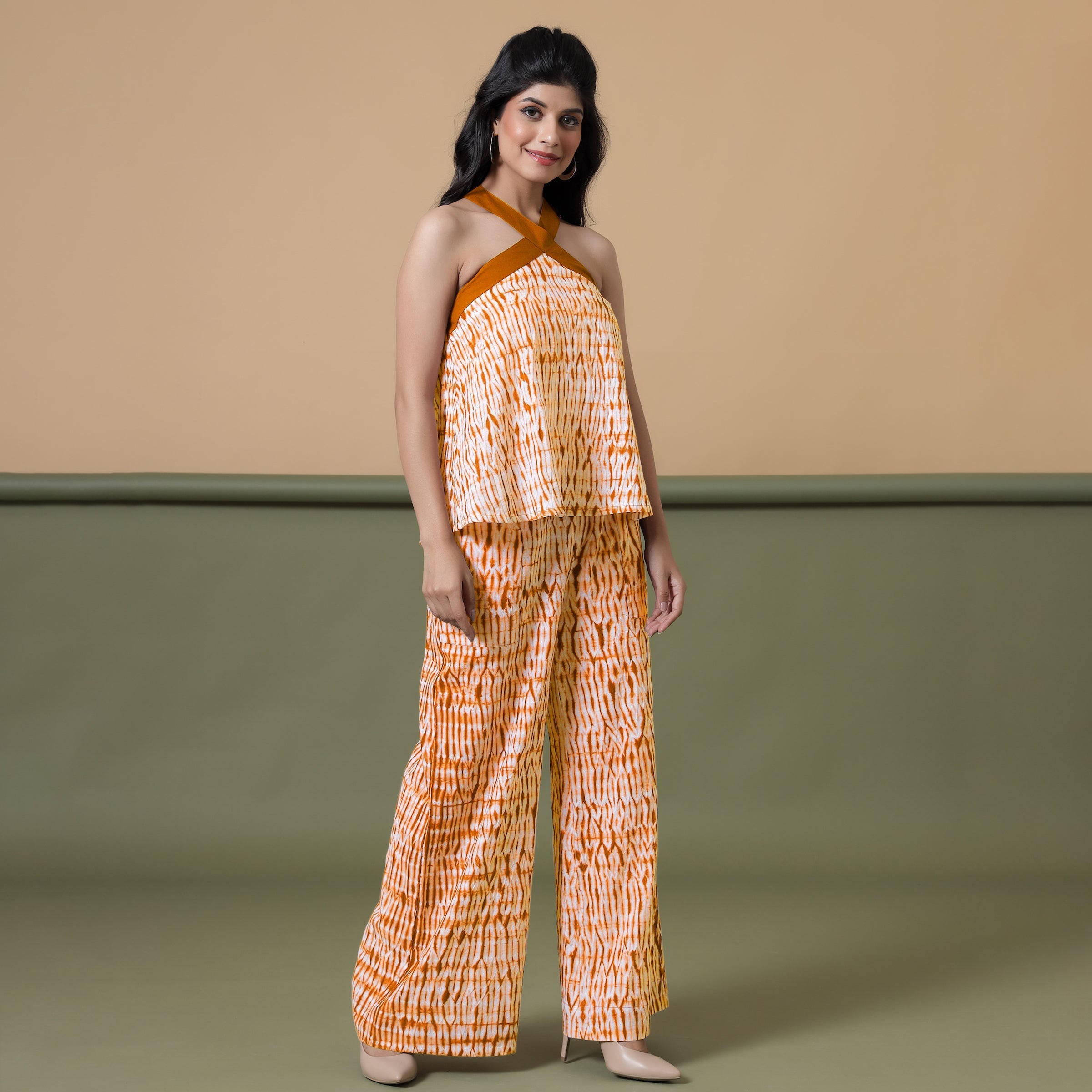 Right View of a Model wearing Shibori Halter Neck Flared Top