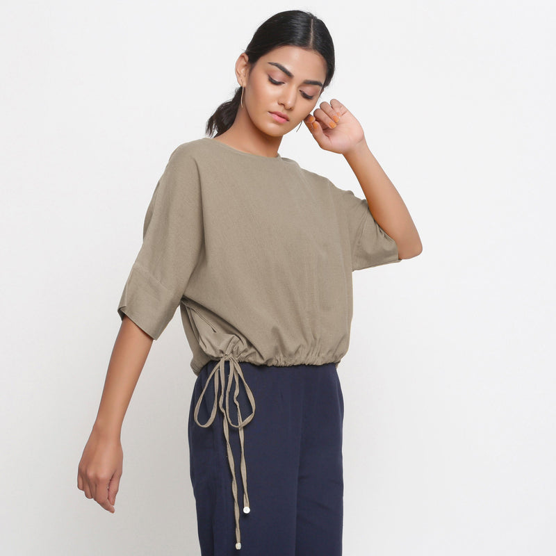 Right View of a Model wearing Solid Beige Cotton Flax Blouson Top