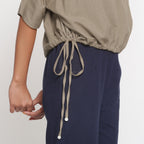 Right Detail of a Model wearing Solid Beige Cotton Flax Blouson Top