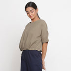 Left View of a Model wearing Solid Beige Cotton Flax Blouson Top
