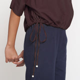 Right Detail of a Model wearing Solid Brown Cotton Flax Blouson Top