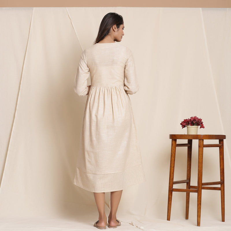 Back View of a Model wearing Dusk Beige Warm Cotton Striped Gathered Midi Dress