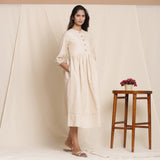 Right View of a Model wearing Dusk Beige Warm Cotton Striped Gathered Midi Dress