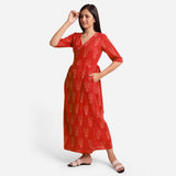 Left View of a Model wearing Sunset Orange Dabu Print 100% Cotton Wrap Dress
