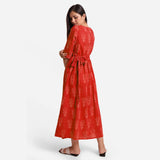 Back View of a Model wearing Sunset Orange Dabu Print 100% Cotton Wrap Dress