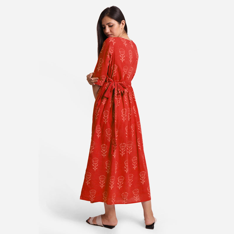 Back View of a Model wearing Sunset Orange Dabu Print 100% Cotton Wrap Dress