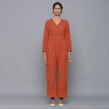 Front View of a Model wearing Sunset Rust Corduroy Comfy Jumpsuit