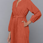 Left Detail of a Model wearing Sunset Rust Corduroy Comfy Jumpsuit