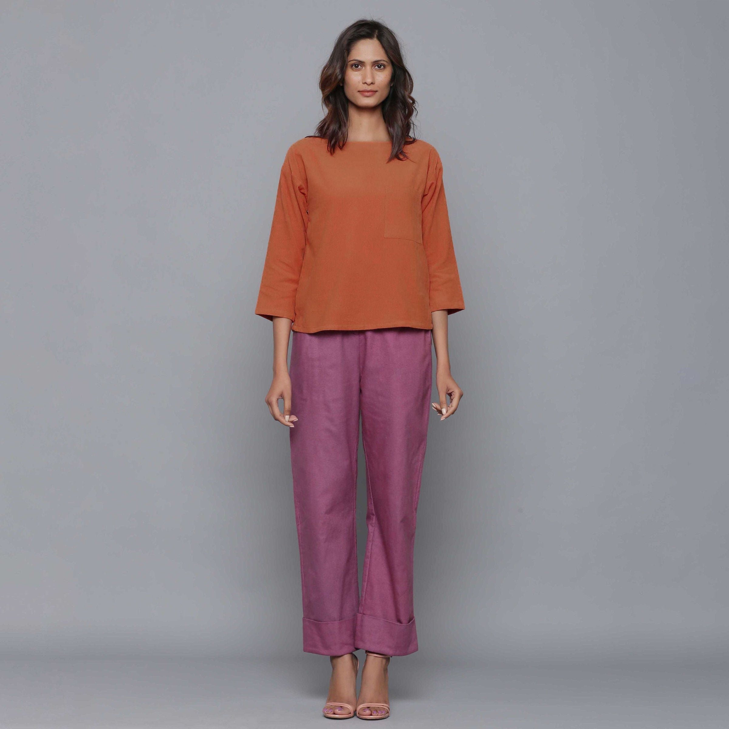 Front View of a Model wearing Sunset Rust Corduroy Drop Shoulder Top