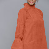 Front Detail of a Model wearing Sunset Rust Corduroy High Neck Dress