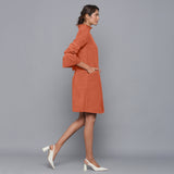 Right View of a Model wearing Sunset Rust Corduroy High Neck Dress