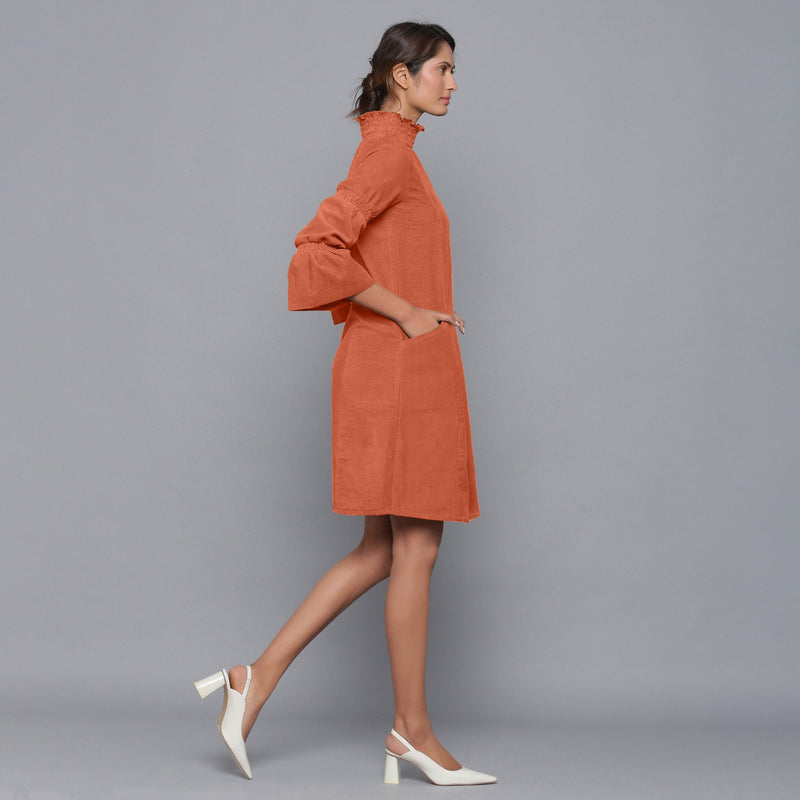 Right View of a Model wearing Sunset Rust Corduroy High Neck Dress