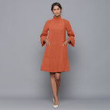 Front View of a Model wearing Sunset Rust Corduroy High Neck Dress