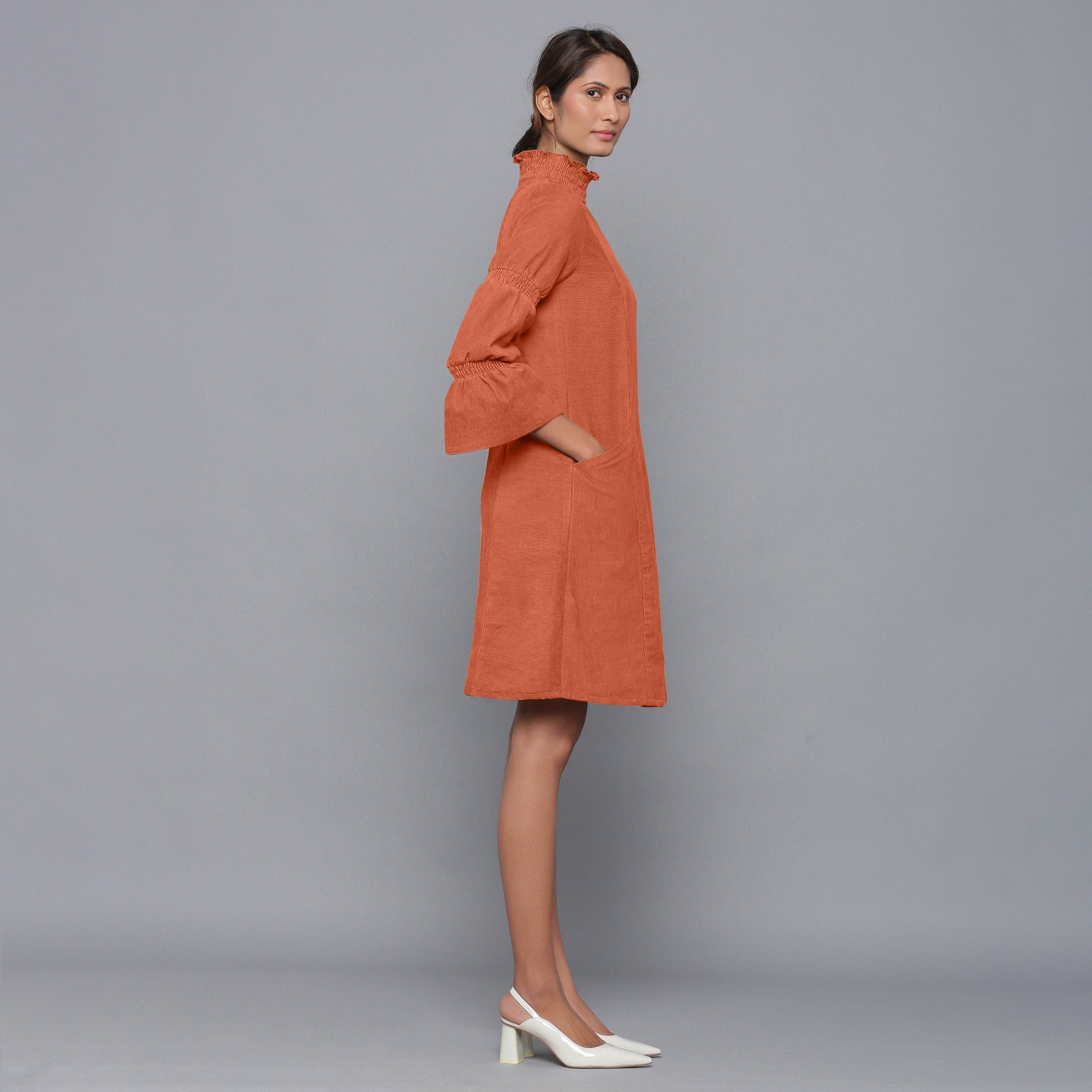Right View of a Model wearing Sunset Rust Corduroy High Neck Dress
