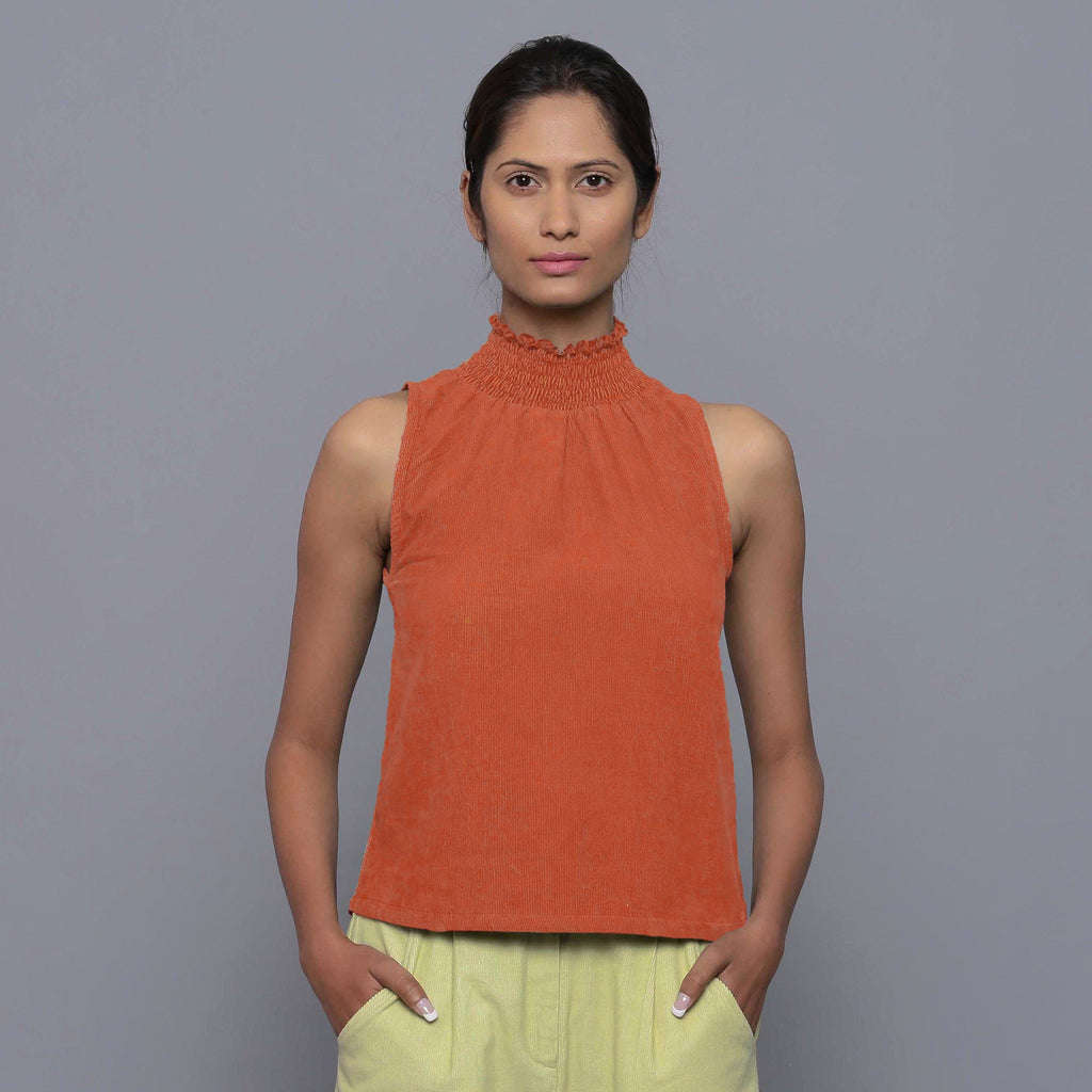 Front View of a Model wearing Sunset Rust Cotton Corduroy High Neck Top