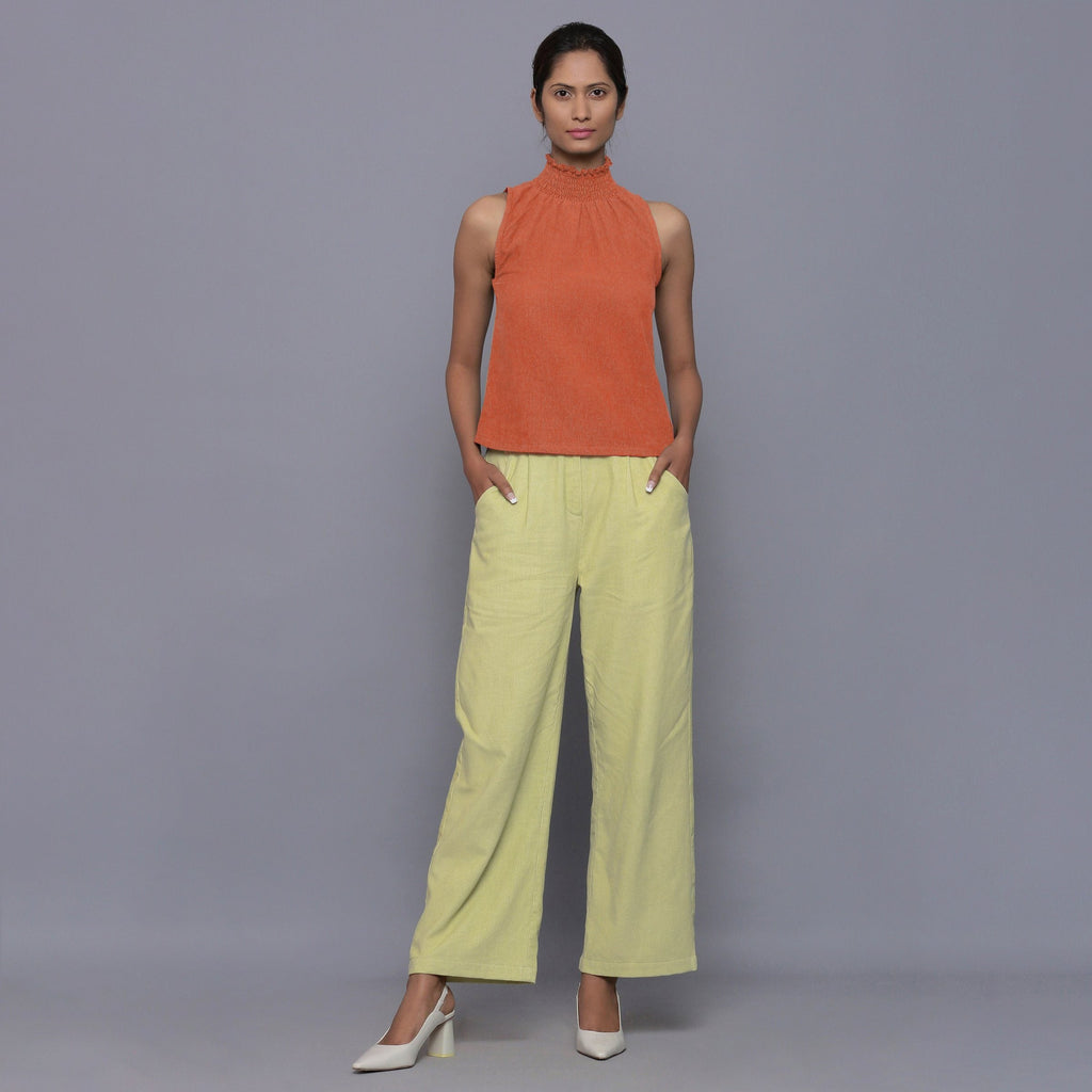 Front View of a Model wearing Sunset Rust Cotton Corduroy High Neck Top