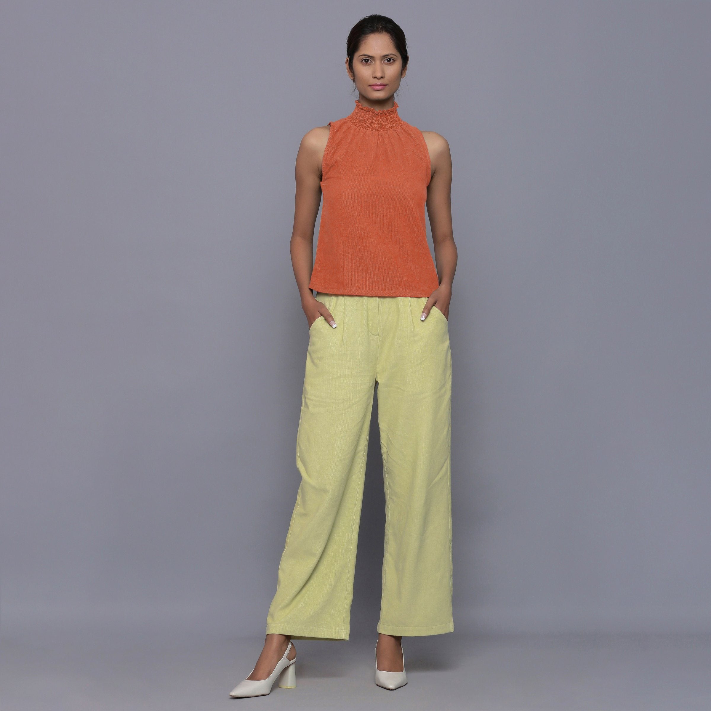Front View of a Model wearing Sunset Rust Cotton Corduroy High Neck Top