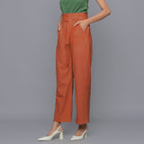 Left View of a Model wearing Sunset Rust Cotton Corduroy Pant
