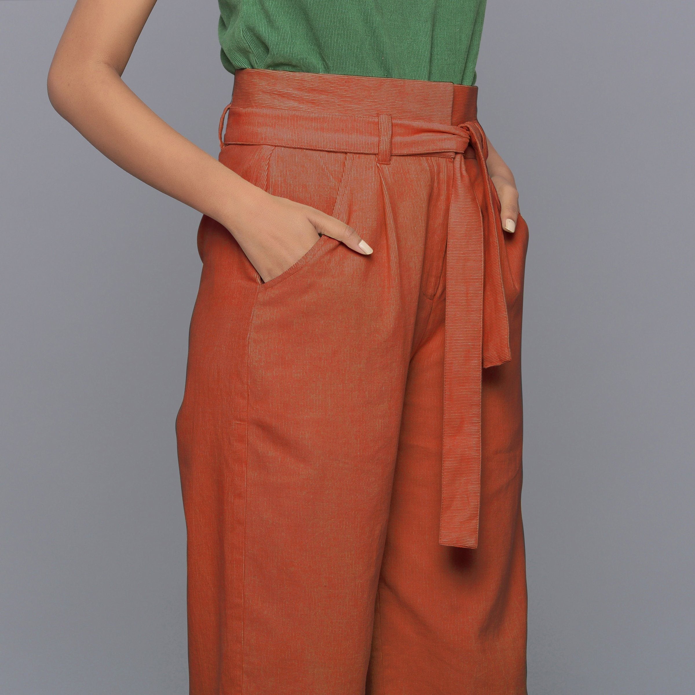 Right Detail of a Model wearing Sunset Rust Cotton Corduroy Pant