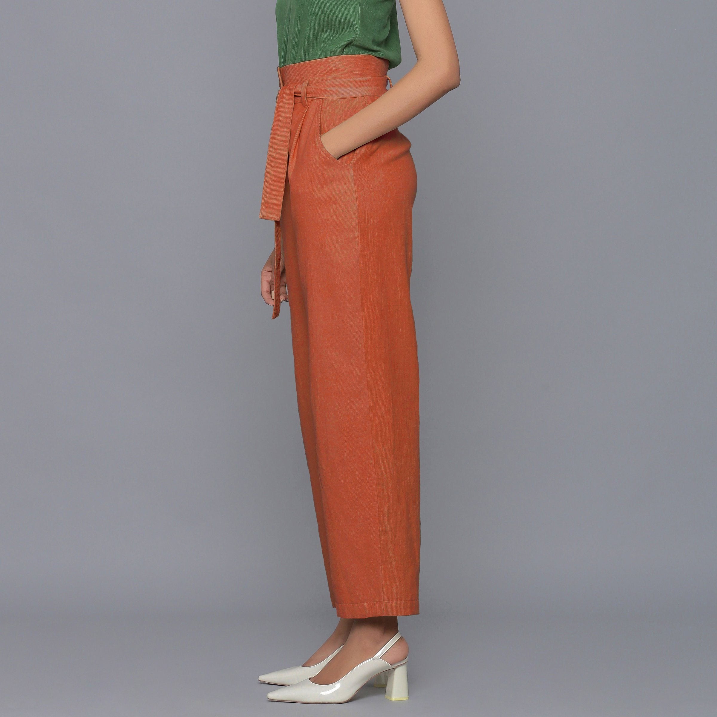 Left View of a Model wearing Sunset Rust Cotton Corduroy Pant