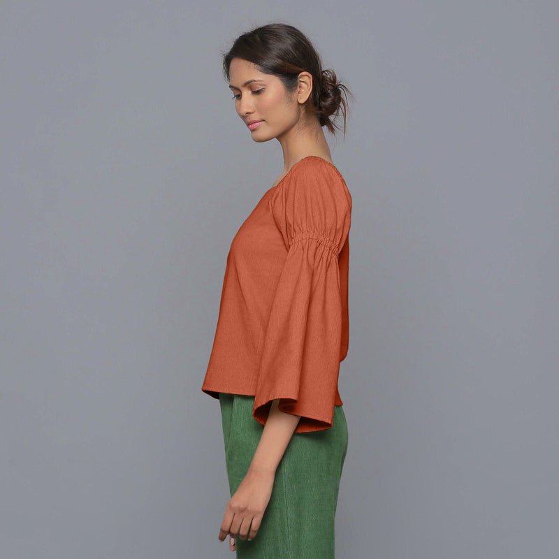 Left View of a Model Sunset Rust Pistachio Corduroy Bohemian Top