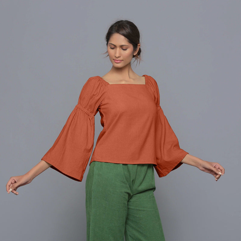 Front View of a Model Sunset Rust Pistachio Corduroy Bohemian Top