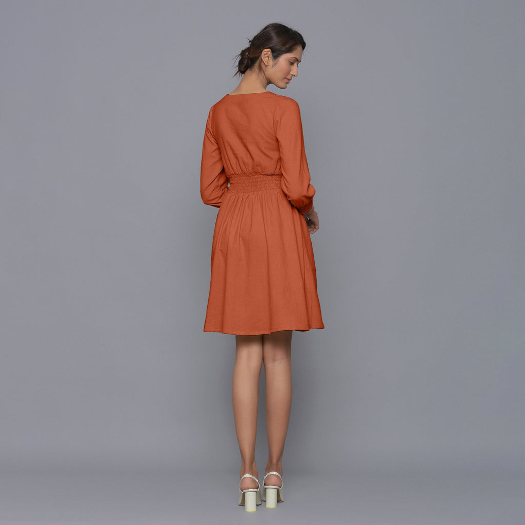 Back View of a Model wearing Sunset Rust V-Neck Corduroy Dress