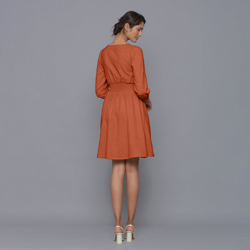 Back View of a Model wearing Sunset Rust V-Neck Corduroy Dress