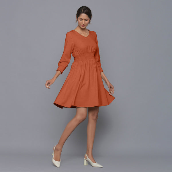 Right View of a Model wearing Sunset Rust V-Neck Corduroy Dress