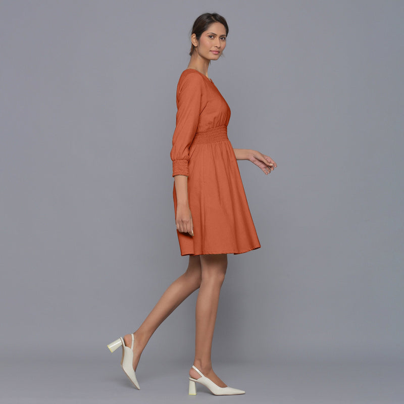 Right View of a Model wearing Sunset Rust V-Neck Corduroy Dress