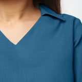 Front Detail of a Model wearing Teal Bracelet Sleeve Straight Top