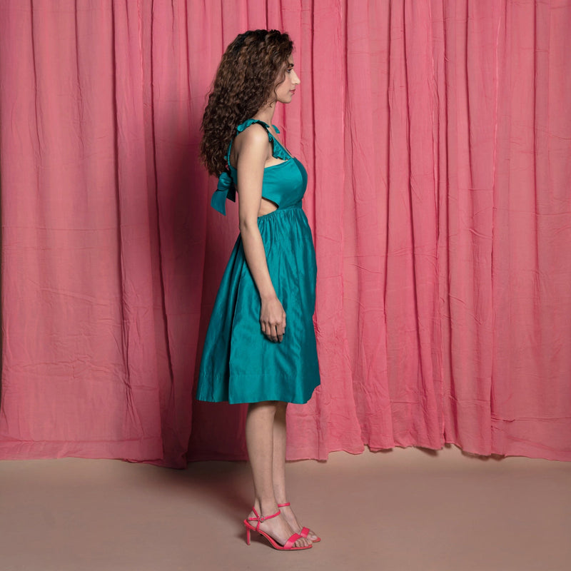 Right View of a Model wearing Teal Cotton Chanderi Knee Length Fit and Flare Dress