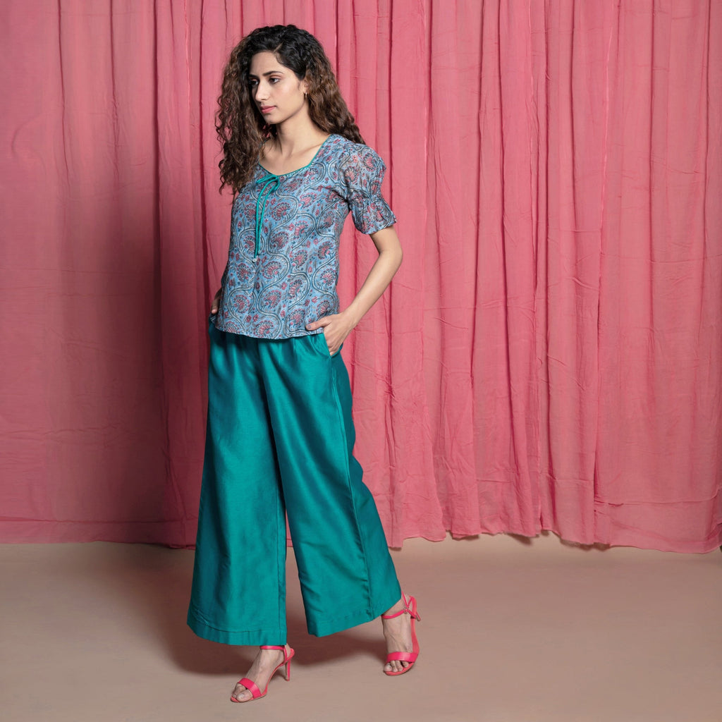 Left View of a Model wearing Teal Hand Block Printed Chanderi Paneled Top
