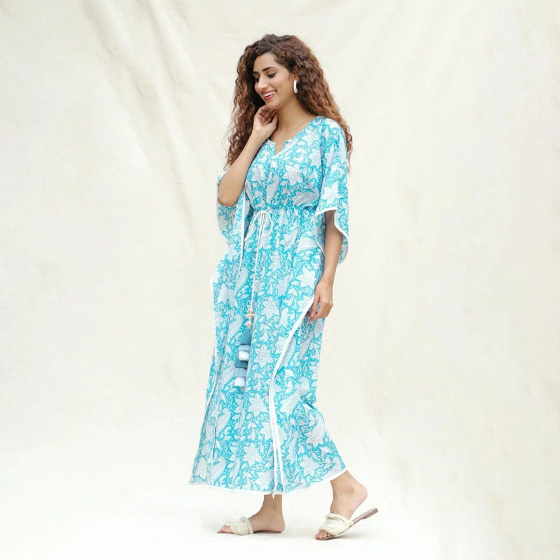 Left View of a Model wearing Turquoise Floral Block Printed Cotton Ankle Length Kaftan Dress