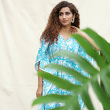 Front View of a Model wearing Turquoise Floral Block Printed Cotton Ankle Length Kaftan Dress