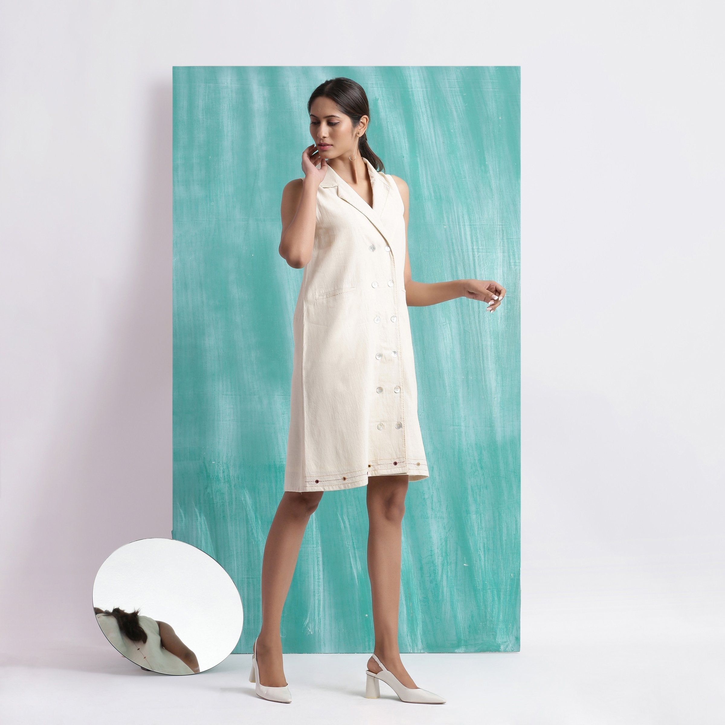 Right View of a Model wearing Off-White Handspun Cotton Muslin Button-Down Short Dress