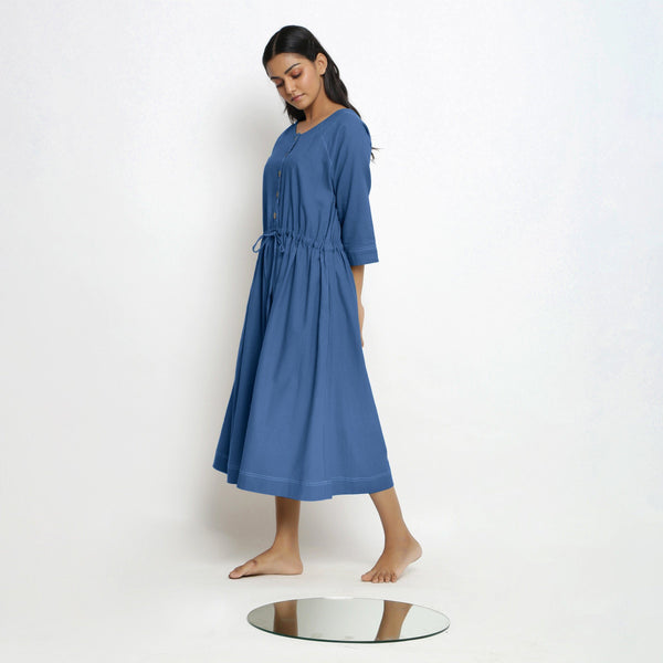 Left View of a Model wearing Vegetable-Dyed Blue 100% Cotton Button-Down Dress