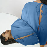 Back View of a Model wearing Vegetable-Dyed Blue 100% Cotton Straight Top