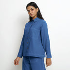 Left View of a Model wearing Vegetable Dyed Blue Button-Down Cotton Top