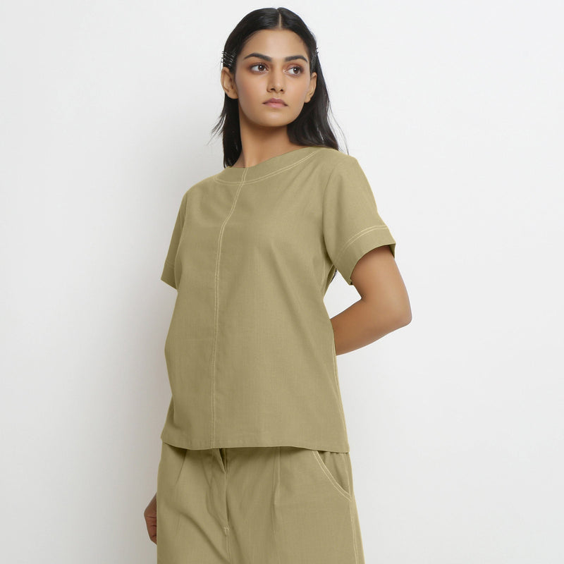 Left View of a Model wearing Vegetable-Dyed Green 100% Cotton Top