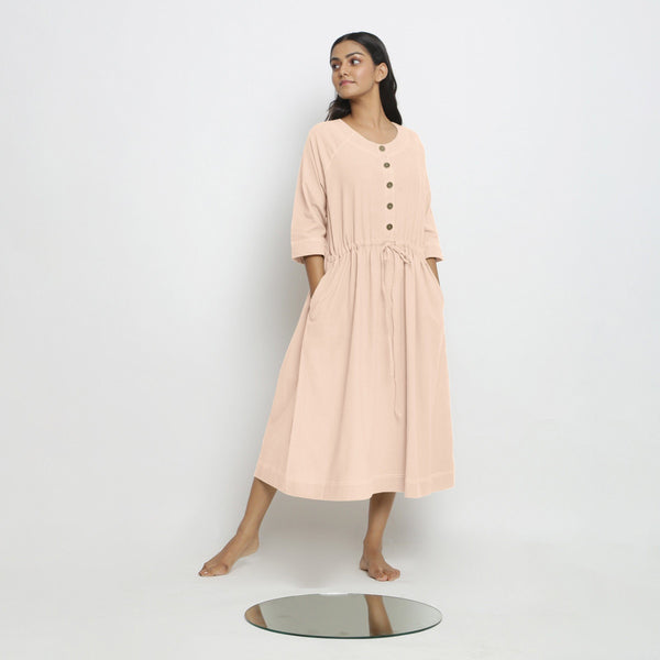 Front View of a Model wearing Vegetable-Dyed Light Pink 100% Cotton Button-Down Dress