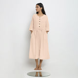 Front View of a Model wearing Vegetable-Dyed Light Pink 100% Cotton Button-Down Dress