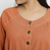 Front Detail of a Model wearing Vegetable-Dyed Orange 100% Cotton Button-Down Dress