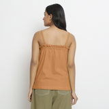 Back View of a Model wearing Vegetable-Dyed Orange 100% Cotton Button-Down Top