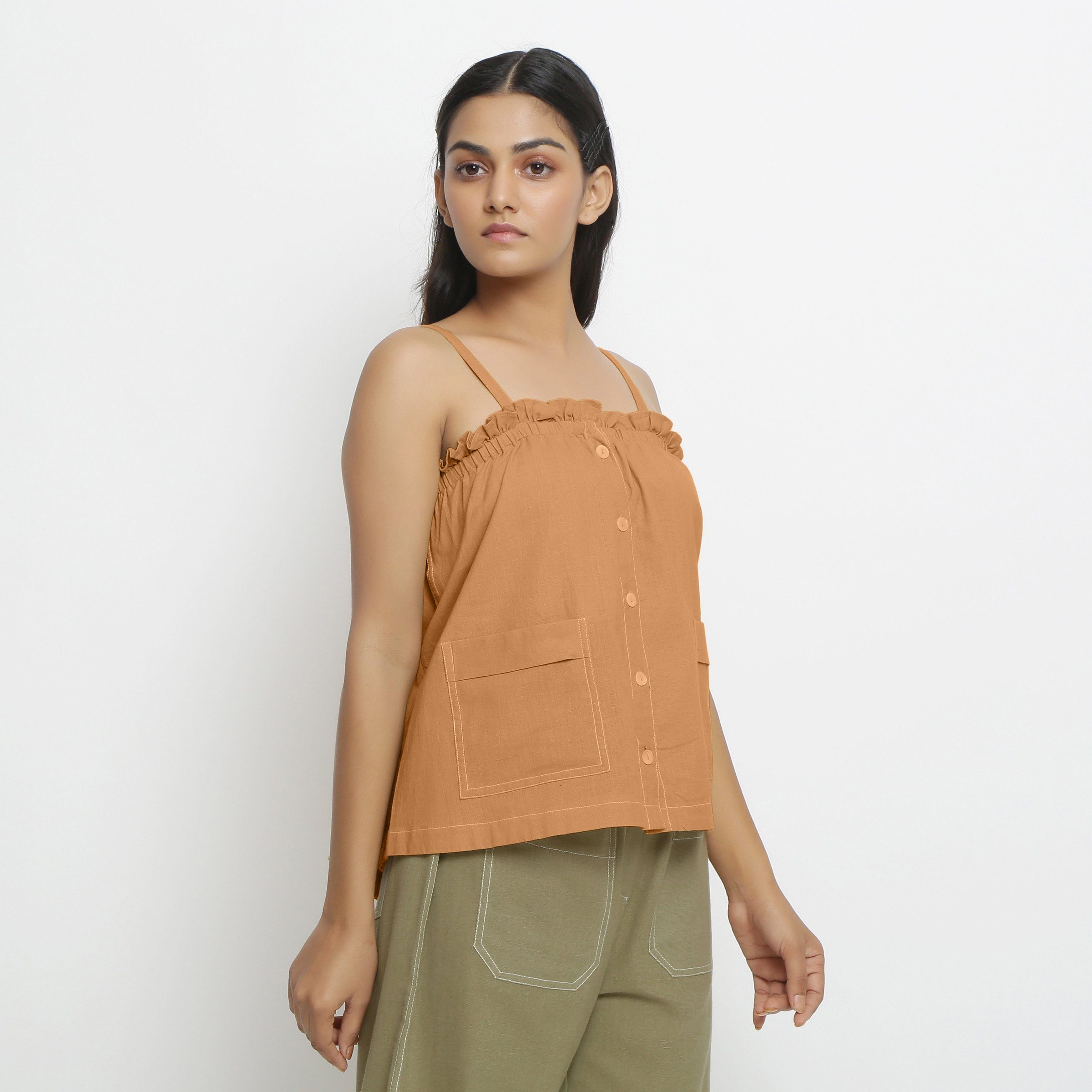 Right View of a Model wearing Vegetable-Dyed Orange 100% Cotton Button-Down Top