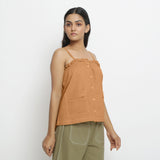 Right View of a Model wearing Vegetable-Dyed Orange 100% Cotton Button-Down Top