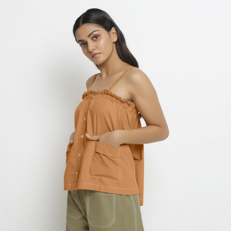 Left View of a Model wearing Vegetable-Dyed Orange 100% Cotton Button-Down Top