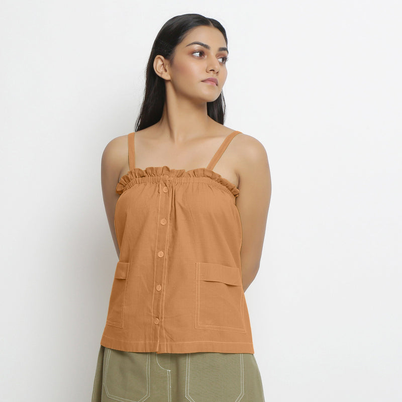 Front View of a Model wearing Vegetable-Dyed Orange 100% Cotton Button-Down Top