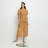 Front View of a Model wearing Vegetable-Dyed Orange 100% Cotton Paneled Top