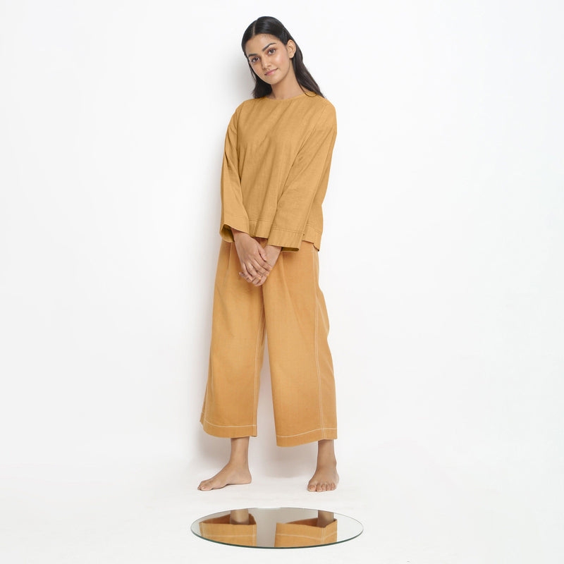 Left View of a Model wearing Vegetable-Dyed Orange 100% Cotton Straight Top